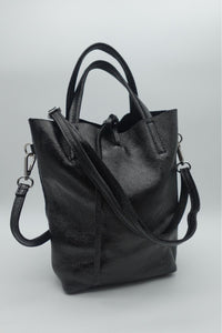 Bolso mini tote negro de piel con acabado brillante y asa larga extraíble, estilo compacto y elegante