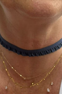 Detalle del choker índigo con fruncido en tejido textil, ajustado al cuello con estilo minimalista