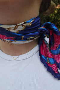 Pañuelo plisado azul y fucsia con estampado navy, anudado al cuello con detalle de cadenas doradas, estilo AnnFou